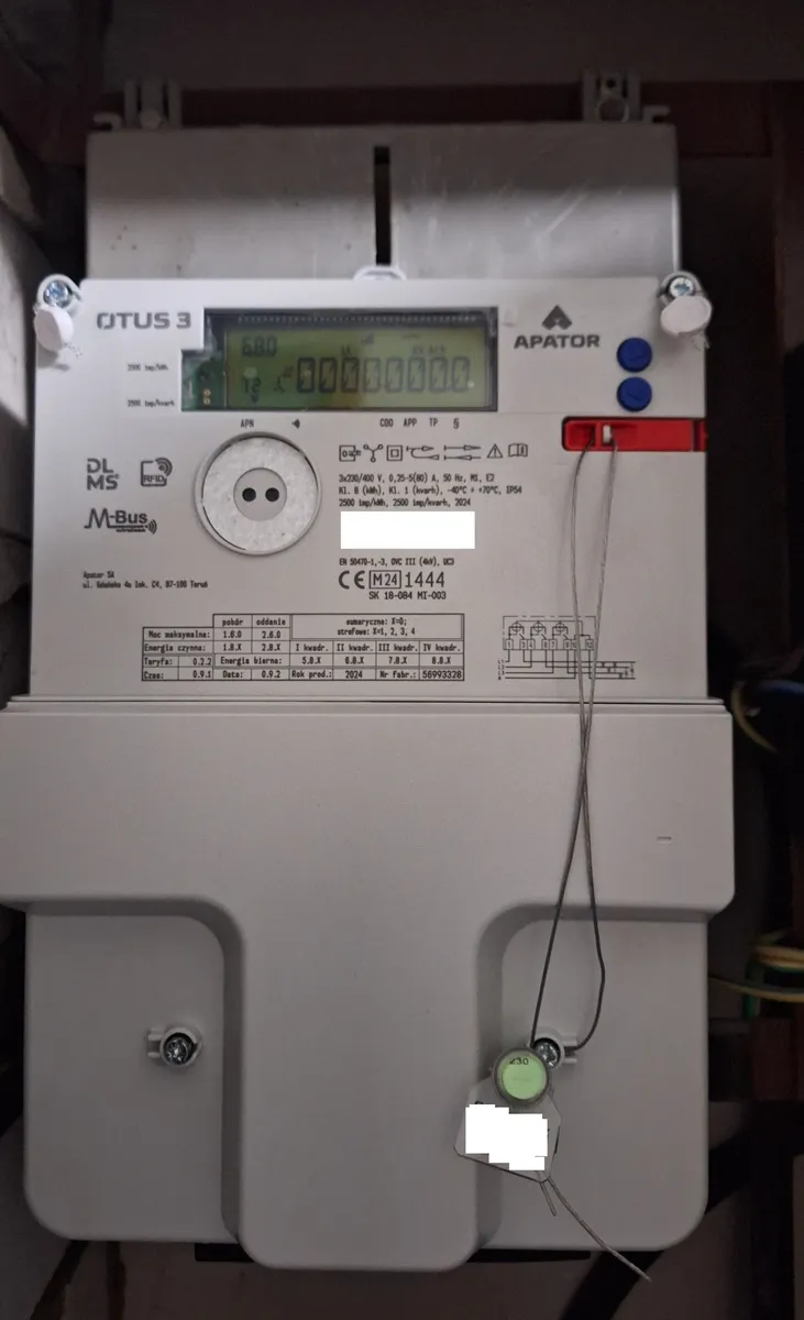 Elektroniczny trójfazowy licznik energii Apator Otus 3 z wyświetlaczem LCD i tabelą rejestrów poboru i oddania energii na obudowie